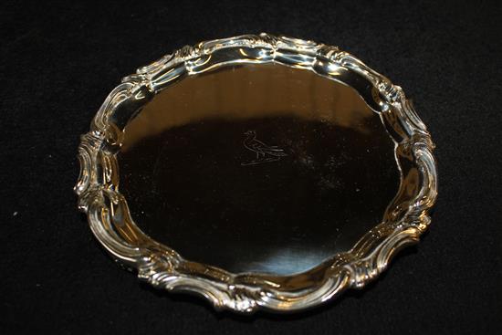 Silver salver, scrolled edge and pierced feet